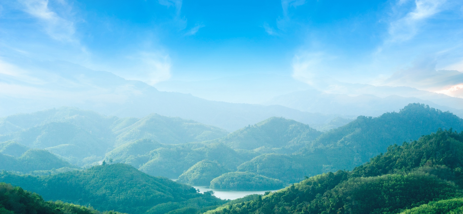 World environment day concept: Green mountains and beautiful blue sky clouds